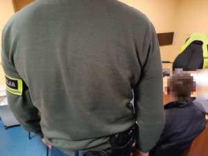 Policjant z zatrzymanym mężczyzną